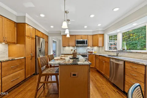 a bedroom with a bed a chandelier and a window