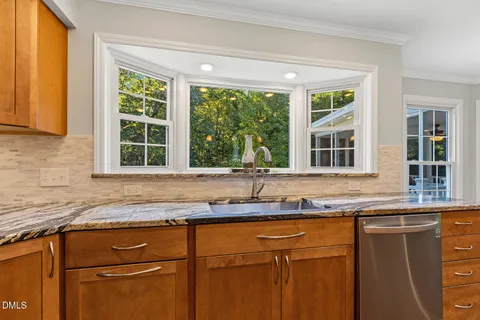 a bathroom with a granite countertop toilet a sink and bathtub