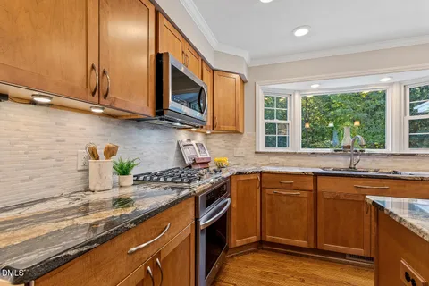 an empty room with windows and ceiling fan