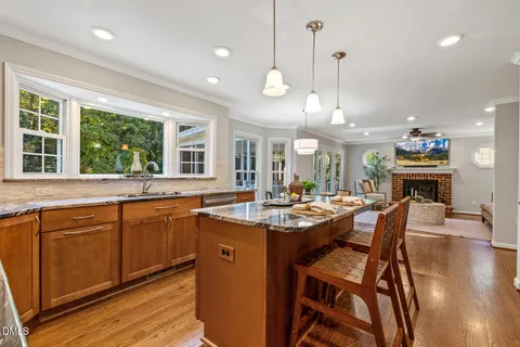a bathroom with a granite countertop toilet sink and mirror