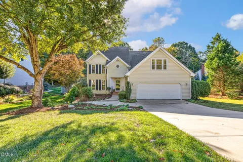 a living room with furniture a fireplace and a large window