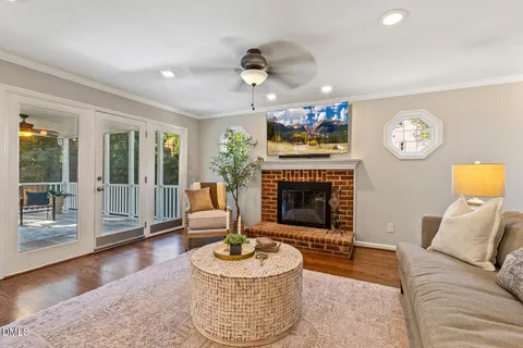a dining room with furniture a chandelier and wooden floor