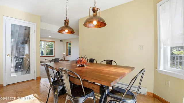 a view of a hallway with wooden floor and stairs