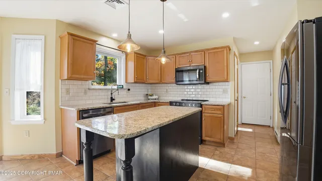 a view of empty room with wooden floor and furniture