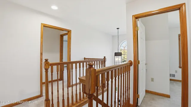 a white toilet sitting next to a white wall