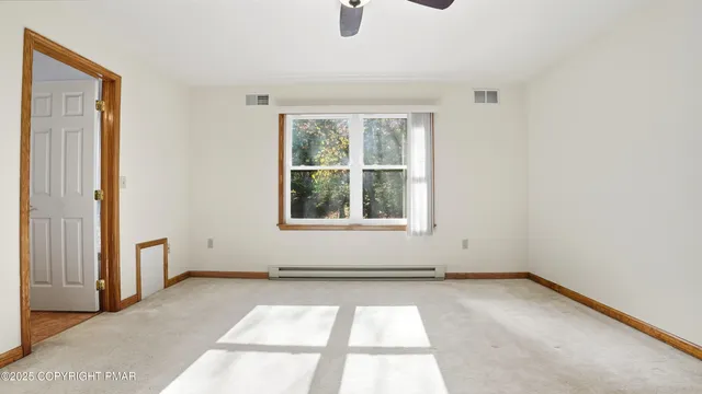 a view of a house with a small yard and wooden floor