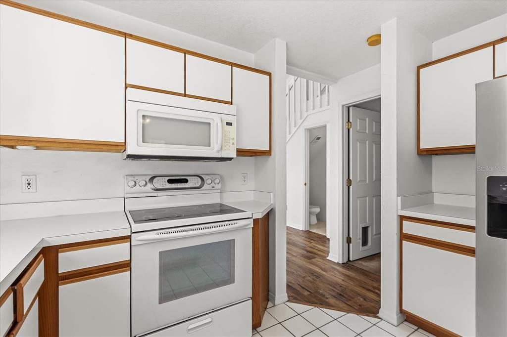 3374 Hamlet Loop Winter Park, FL 32792 - Photo 11 of 37 a kitchen with stainless steel appliances a stove a microwave and a refrigerator