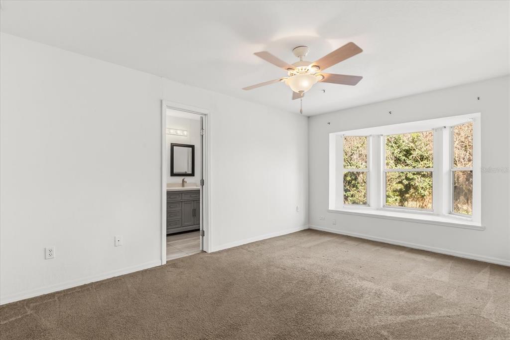 3374 Hamlet Loop Winter Park, FL 32792 - Photo 12 of 37 an empty room with a window and a fan