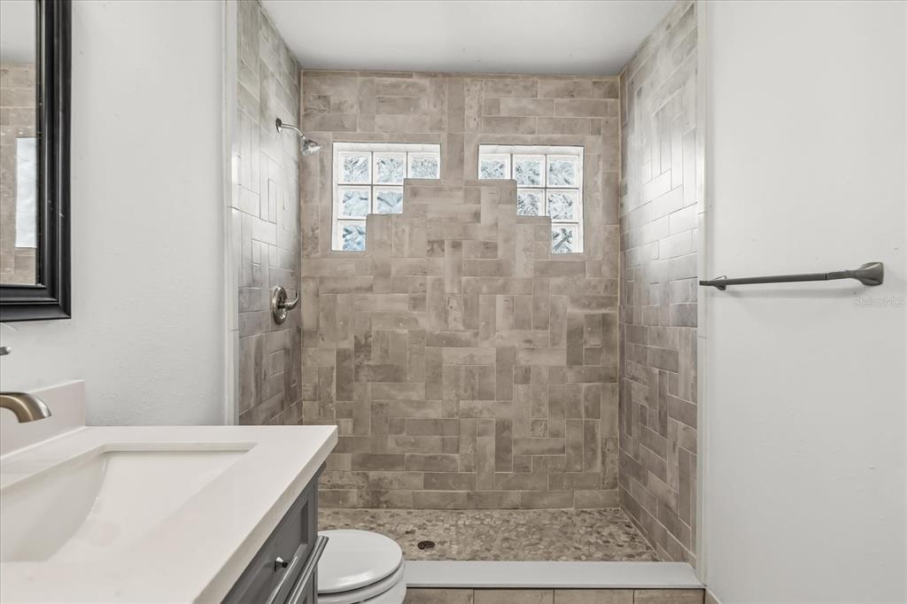 3374 Hamlet Loop Winter Park, FL 32792 - Photo 15 of 37 a bathroom with a bathtub shower sink vanity and toilet