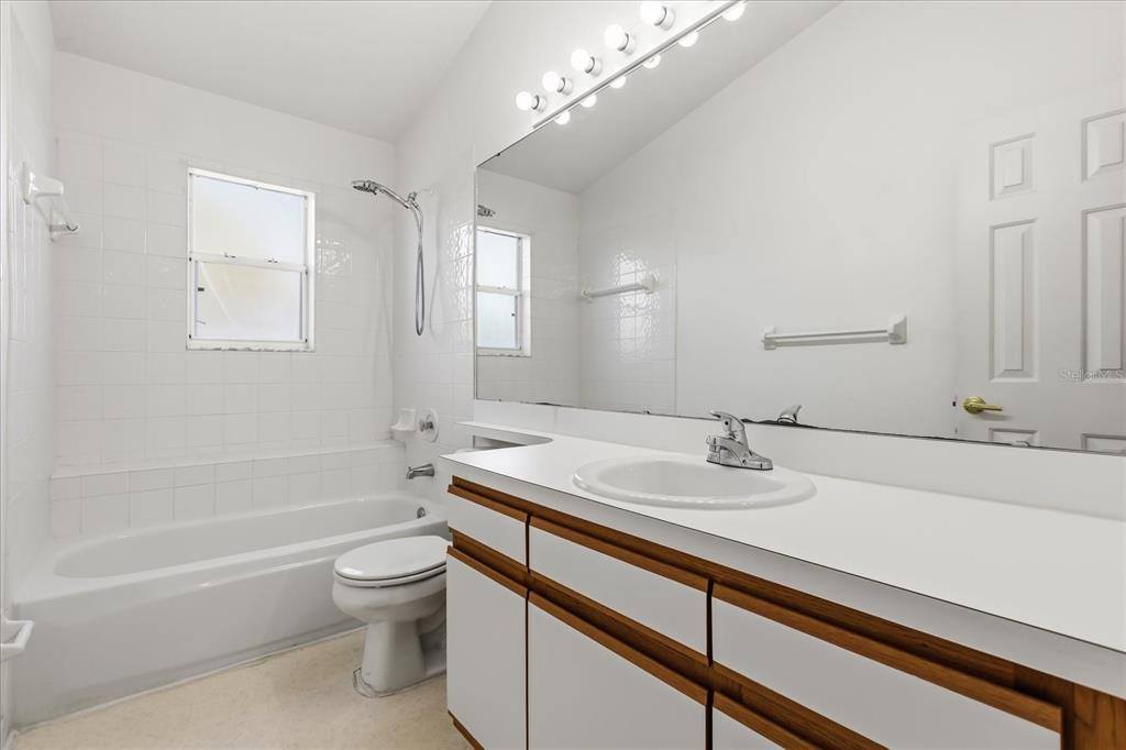 3374 Hamlet Loop Winter Park, FL 32792 - Photo 19 of 37 a bathroom with a sink a toilet and shower