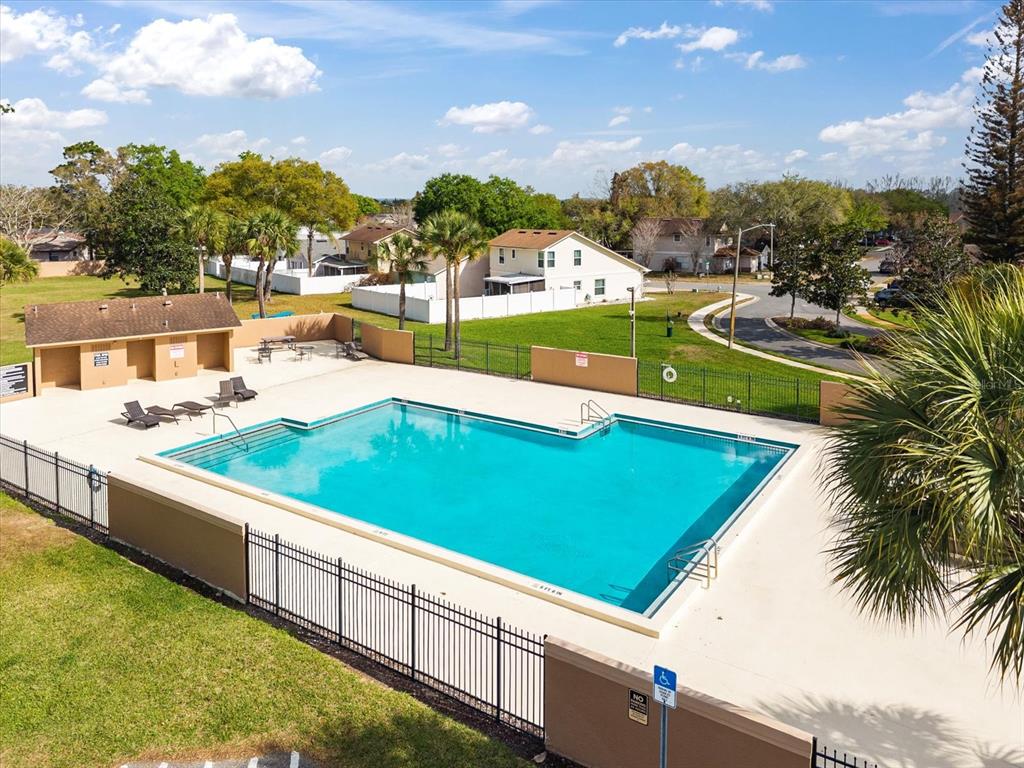 3374 Hamlet Loop Winter Park, FL 32792 - Photo 30 of 37 a view of a swimming pool with lawn chairs under an umbrella