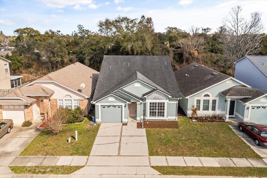 3374 Hamlet Loop Winter Park, FL 32792 - Photo 37 of 37 a front view of a house with a yard