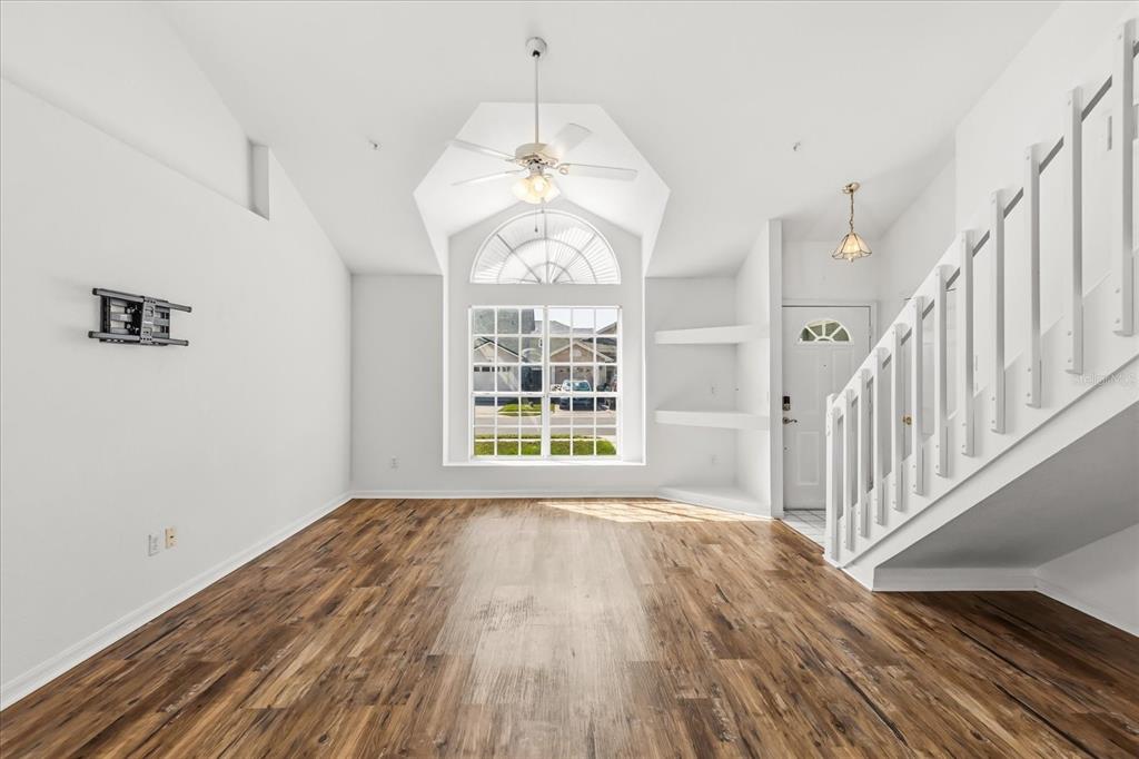 3374 Hamlet Loop Winter Park, FL 32792 - Photo 4 of 37 a view of an empty room with wooden floor and a window