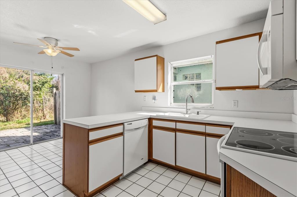 3374 Hamlet Loop Winter Park, FL 32792 - Photo 7 of 37 a kitchen with a sink stove and cabinets