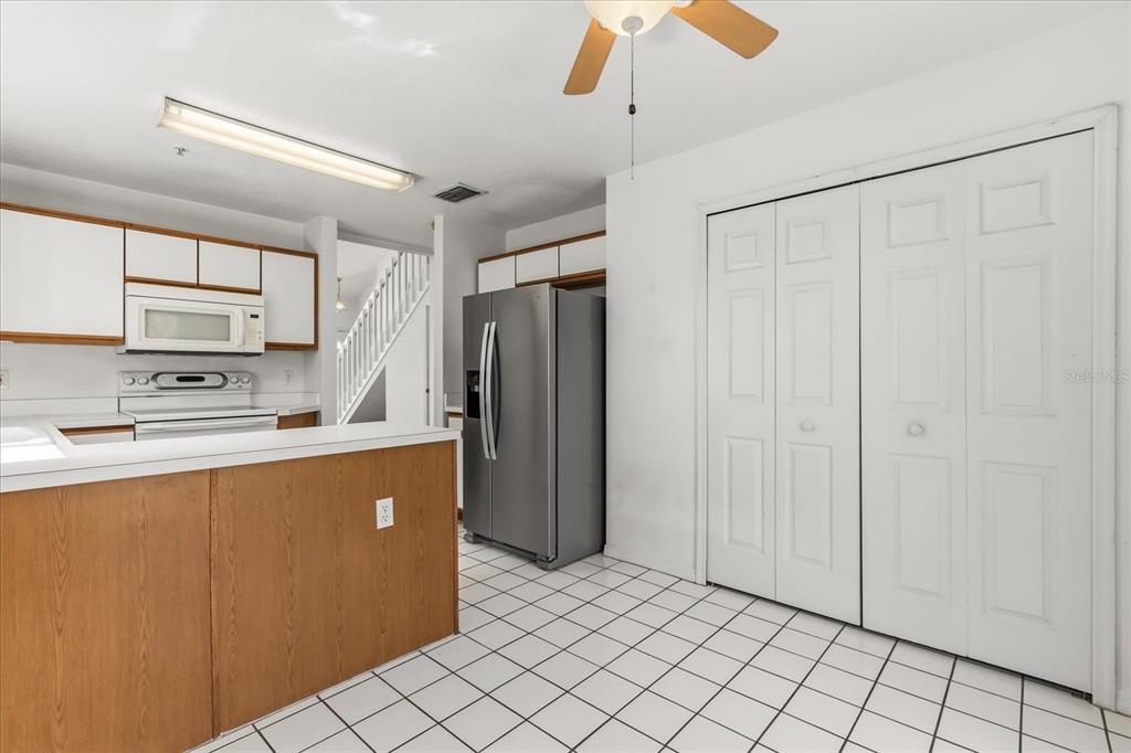 3374 Hamlet Loop Winter Park, FL 32792 - Photo 9 of 37 a kitchen with stainless steel appliances a refrigerator and a stove top oven
