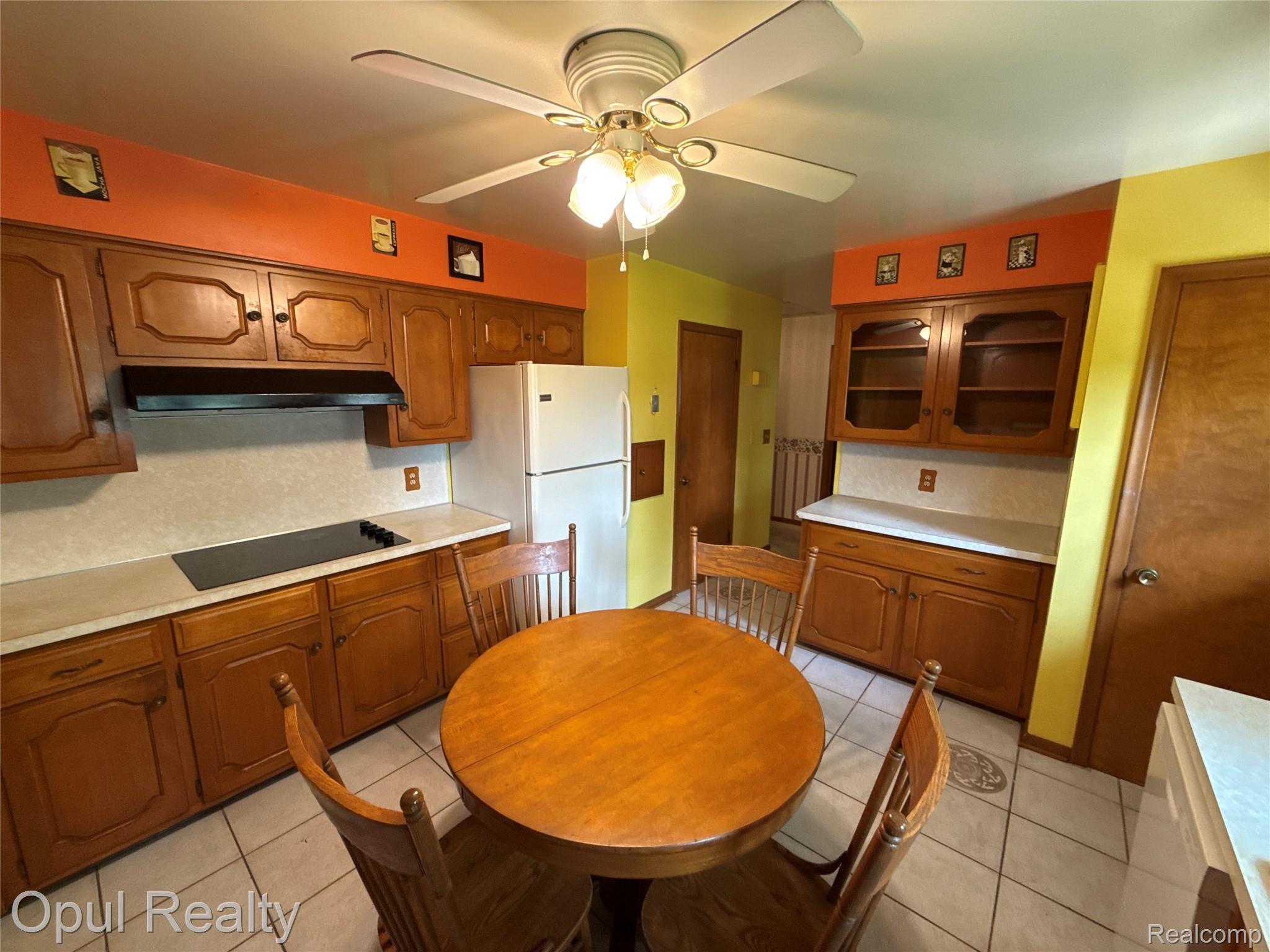 7899 Ida East Road Ida, MI 48140 - Photo 25 of 48 Kitchen featuring wood cabinetry, white countertops, built-in cooktop, and a ceiling fan with integrated lighting