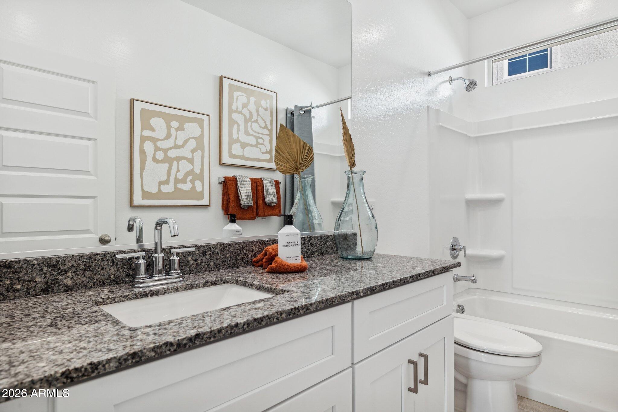 26449 West Crown King Road Buckeye, AZ 85326 - Photo 27 of 33 a bathroom with a granite countertop sink and a mirror