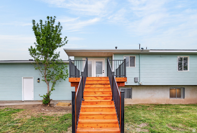 489 Owens Street Layton, UT 84041 - Photo 25 of 25 Rear view of house with stairway and a yard