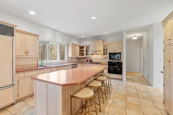 a kitchen with stainless steel appliances granite countertop a sink and a refrigerator