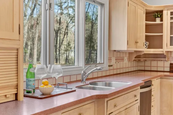 a kitchen with a sink and a window