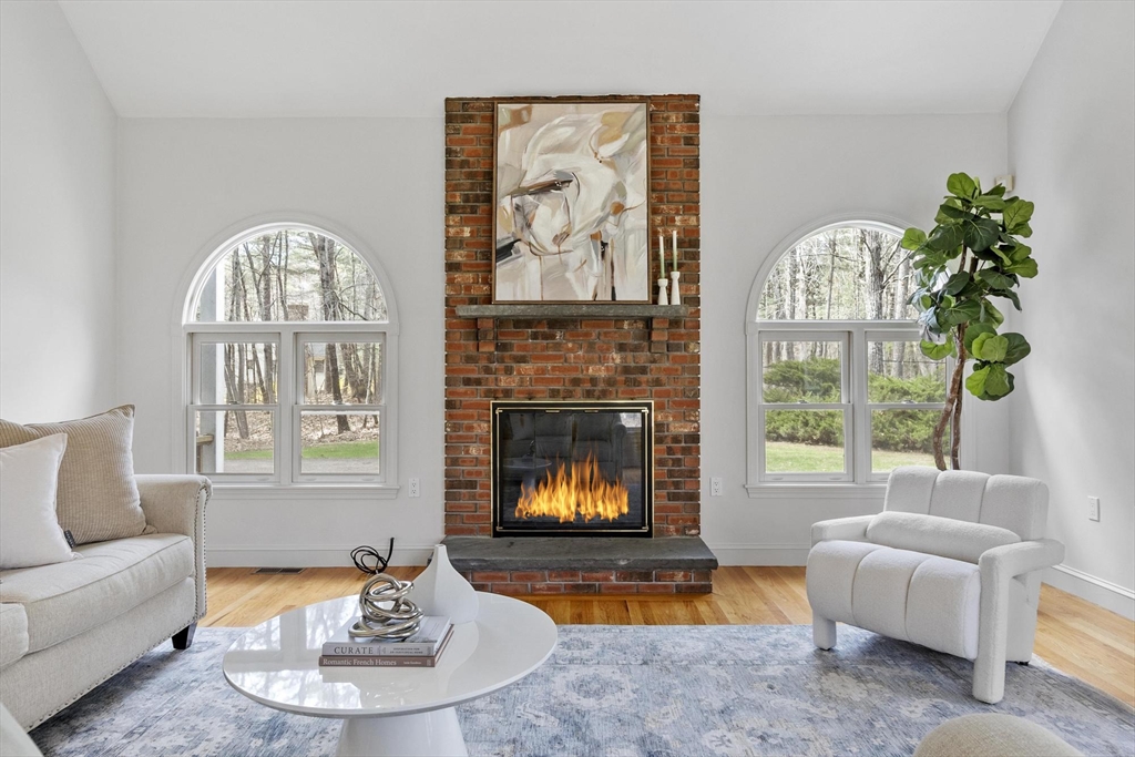 78 Cutters Ridge Road Carlisle, MA 01741 - Photo 17 of 42 a living room with furniture a fireplace and a large window