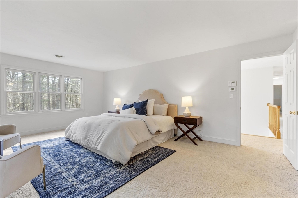 78 Cutters Ridge Road Carlisle, MA 01741 - Photo 26 of 42 a bedroom with a large bed a rug and windows