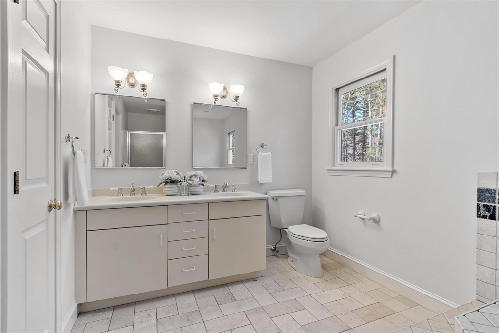 78 Cutters Ridge Road Carlisle, MA 01741 - Photo 28 of 42 a bathroom with a toilet sink and mirror
