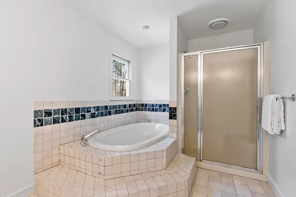 a bathroom with a tub and shower
