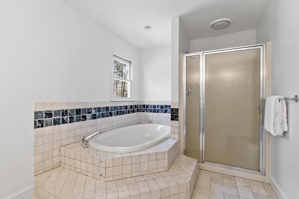 78 Cutters Ridge Road Carlisle, MA 01741 - Photo 29 of 42 a bathroom with a tub and shower