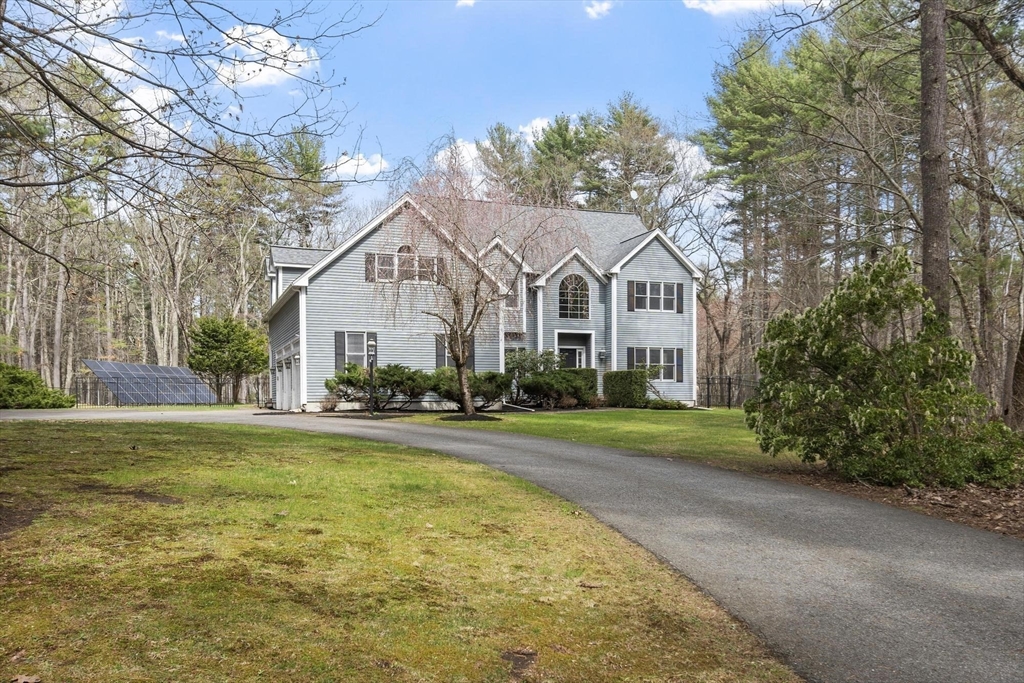 78 Cutters Ridge Road Carlisle, MA 01741 - Photo 42 of 42 a front view of a house with a yard and garage