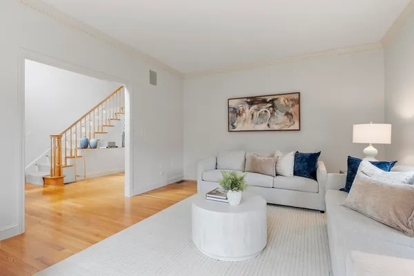 a living room with furniture and wooden floor