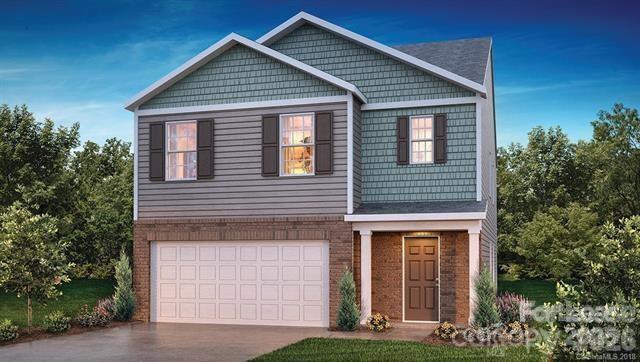 3973 BETHESDA Place Concord, NC 28025 - Photo 1 of 12 a front view of a house with garden