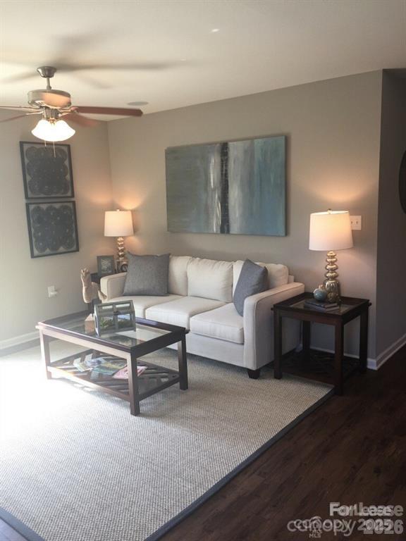 3973 BETHESDA Place Concord, NC 28025 - Photo 2 of 12 a living room with furniture and a lamp