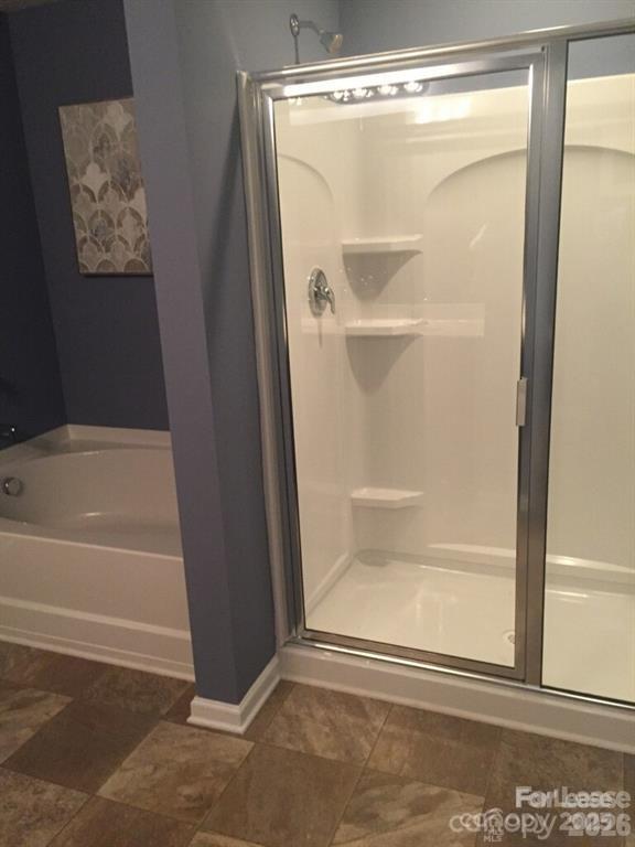 3973 BETHESDA Place Concord, NC 28025 - Photo 7 of 12 a bathroom with a glass shower door
