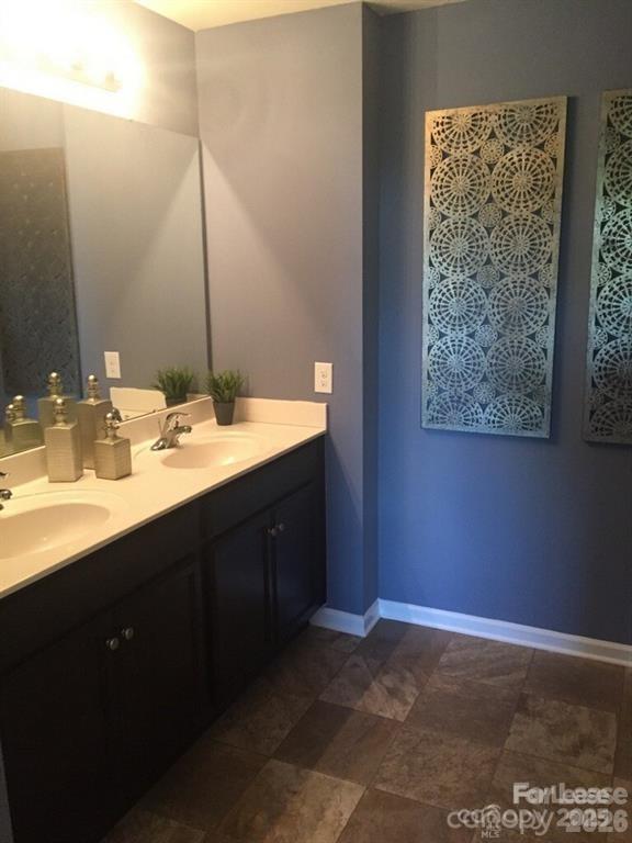 3973 BETHESDA Place Concord, NC 28025 - Photo 8 of 12 a bathroom with a sink vanity and a mirror