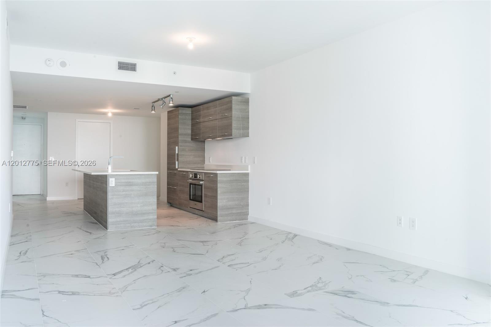 650 Northeast 32nd Street, Unit 2804 Miami, FL 33137 - Photo 11 of 48 a view of a kitchen with refrigerator and microwave