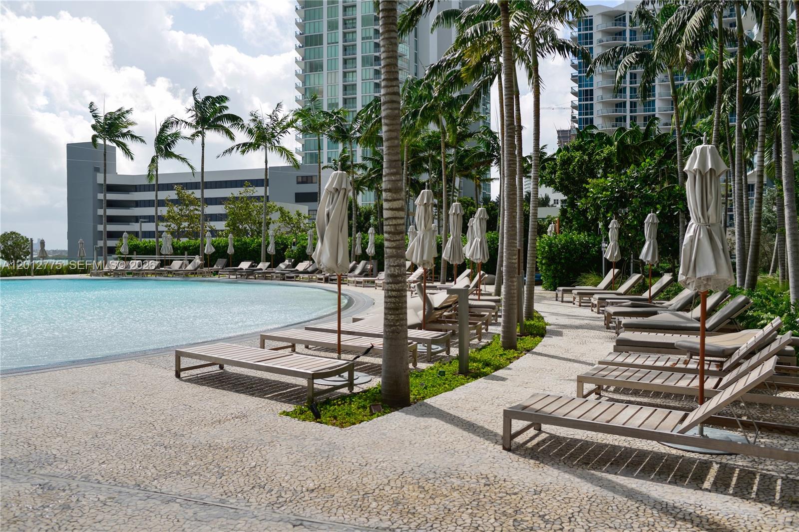 650 Northeast 32nd Street, Unit 2804 Miami, FL 33137 - Photo 24 of 48 a view of a patio with a table chairs and a fire pit