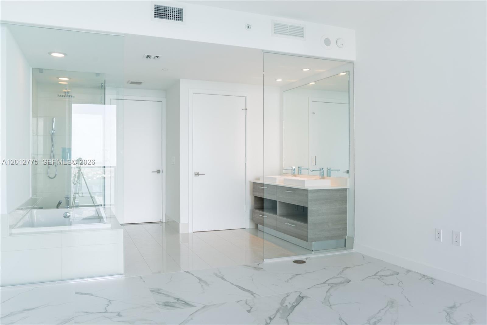 650 Northeast 32nd Street, Unit 2804 Miami, FL 33137 - Photo 5 of 48 a bathroom with a sink a toilet and shower