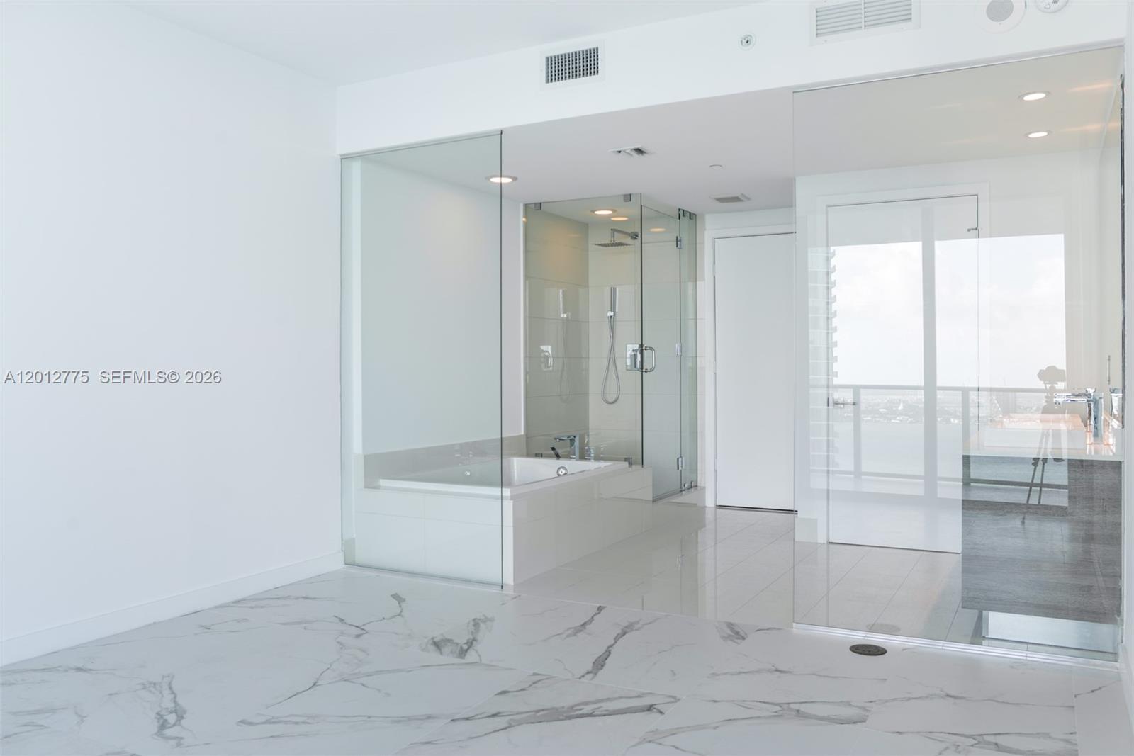 650 Northeast 32nd Street, Unit 2804 Miami, FL 33137 - Photo 7 of 48 a bathroom with a bathtub and a shower