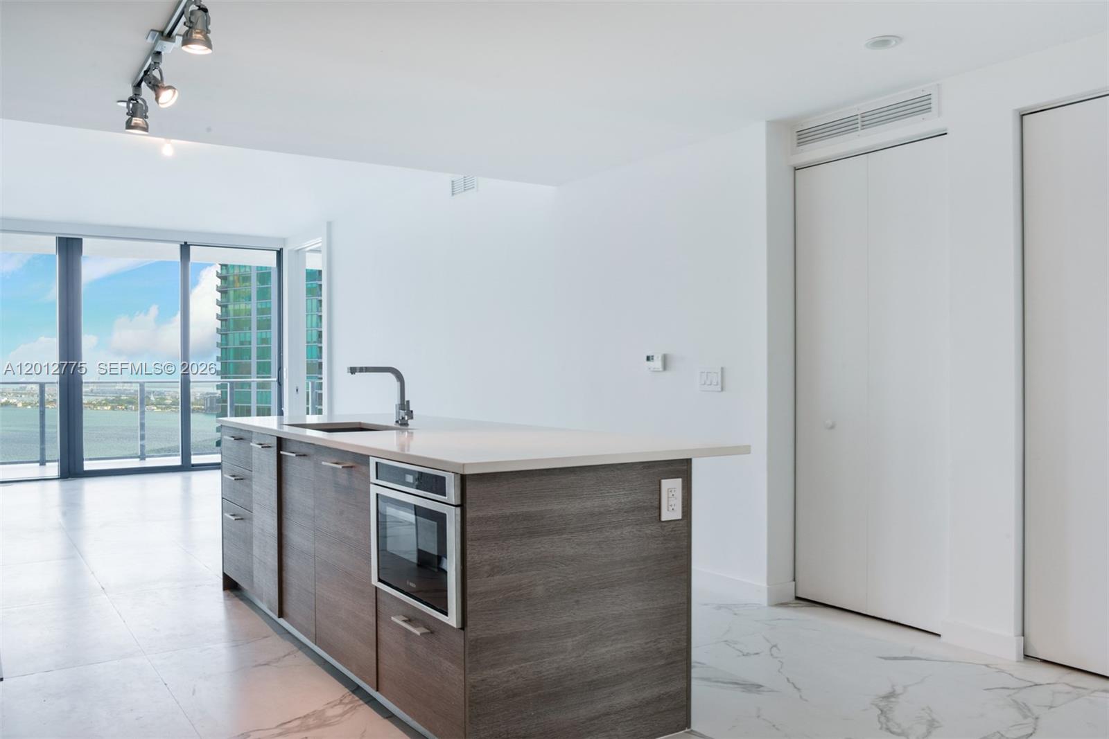650 Northeast 32nd Street, Unit 2804 Miami, FL 33137 - Photo 10 of 48 a kitchen with stainless steel appliances granite countertop a stove and a refrigerator