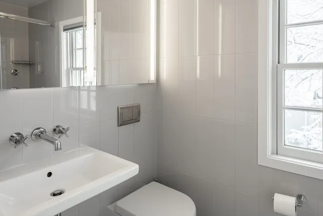 a white toilet sitting next to a bathroom sink