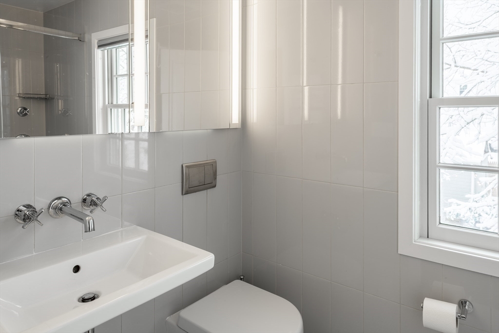 78 Howitt Road Boston, MA 02132 - Photo 11 of 20 a white toilet sitting next to a bathroom sink