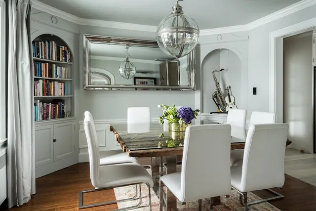 a view of a dining room with furniture wooden floor and chandelier