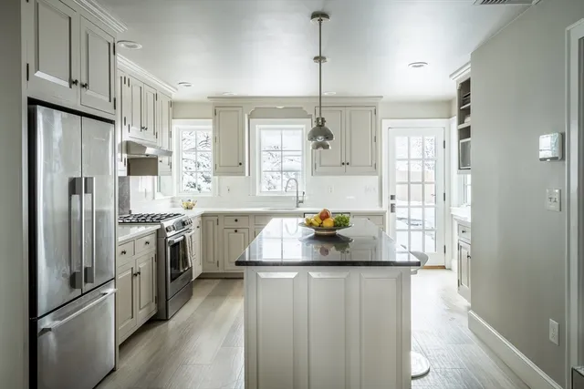 a kitchen with a refrigerator sink and stove