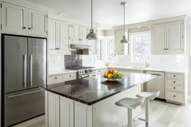 a kitchen with stainless steel appliances a sink a refrigerator a counter space and stainless steel appliances