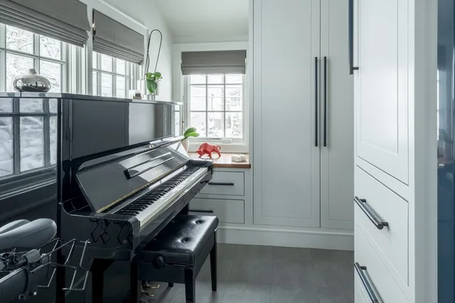 a room with chairs and a window