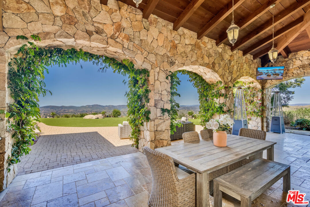 18000 Sunset Point Road Poway, CA 92064 - Photo 11 of 43 a view of a terrace with furniture and a potted plant