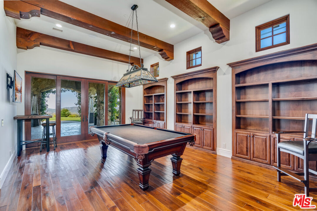 18000 Sunset Point Road Poway, CA 92064 - Photo 12 of 43 a living room with furniture a bookshelf and wooden floors