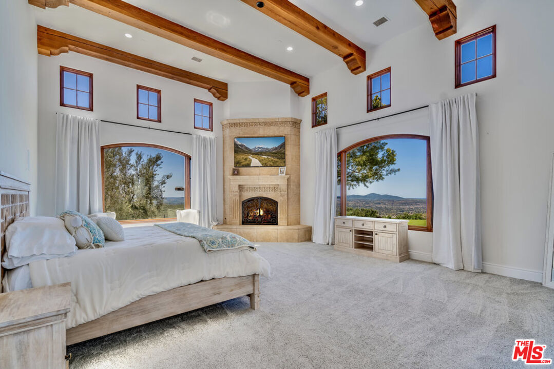 18000 Sunset Point Road Poway, CA 92064 - Photo 14 of 43 a spacious bedroom with a bed and a couch