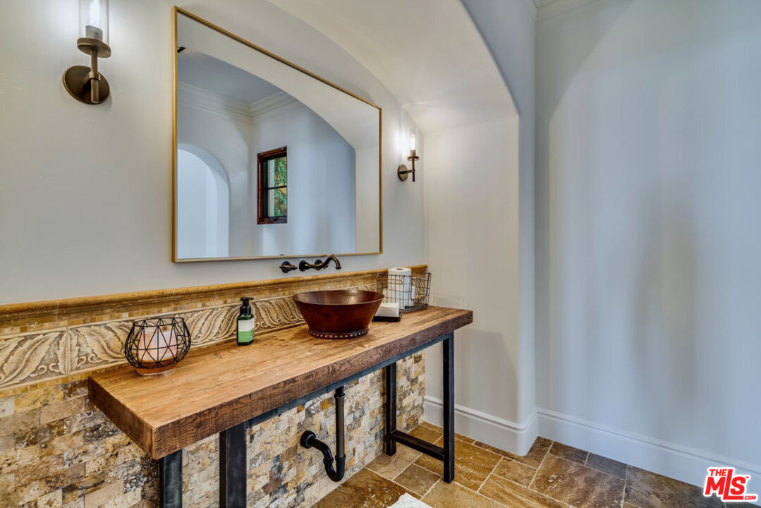 18000 Sunset Point Road Poway, CA 92064 - Photo 24 of 43 a bathroom with a sink and a mirror